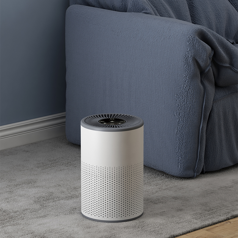 Compacte luchtreiniger Luna naast bank voor schonere lucht in huis