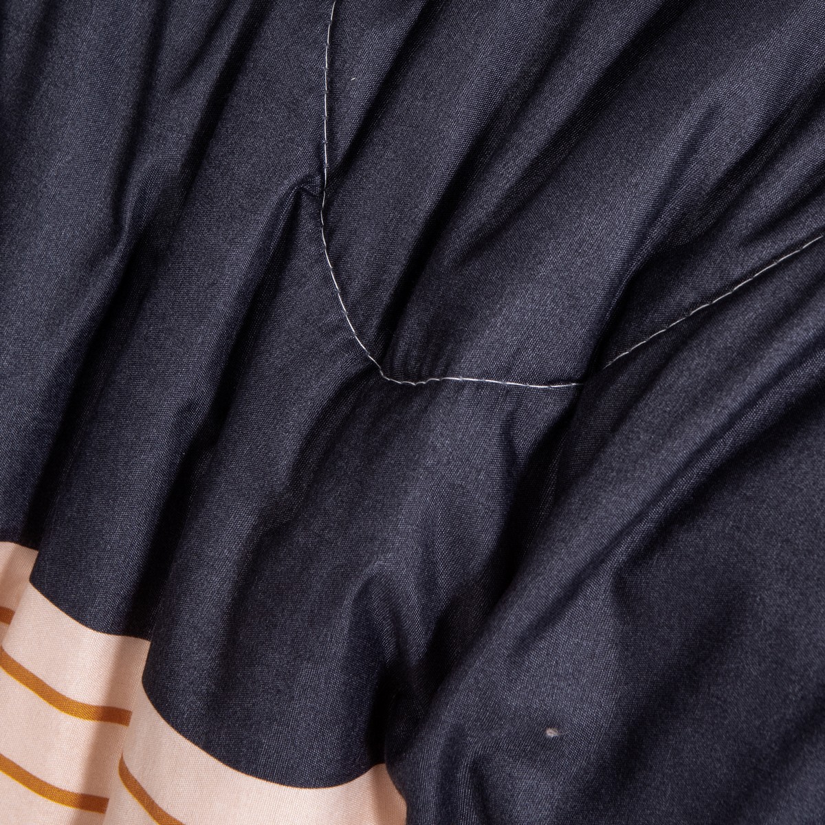 Close-up van de stof en stiknaden van het 2-delige 4-seizoenen dekbed Emma met vaste overtrek